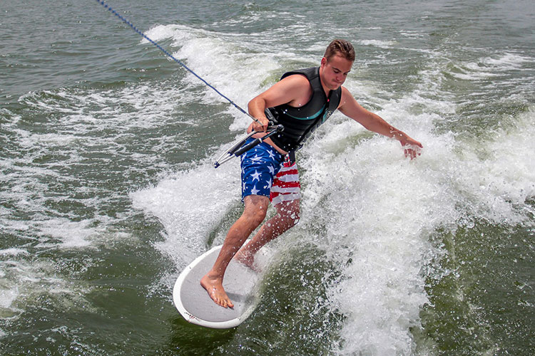 When towing wakeboarders, how fast do wakeboard boats travel?